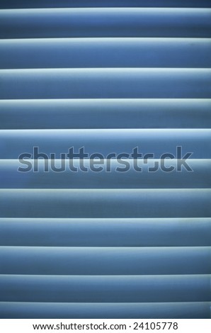 Vertical image of venetian blinds back-lit
