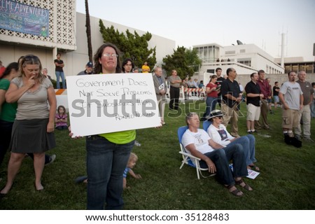 ALHAMBRA, CA - AUGUST 11: A woman holds up a sign in protest at a healthcare rally held by U.S. Congressman Adam Schiff (D-CA) on August 11, 2009 in Alhambra.