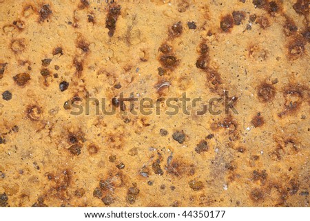 Detail image of a pitted metal surface, with rust marks.