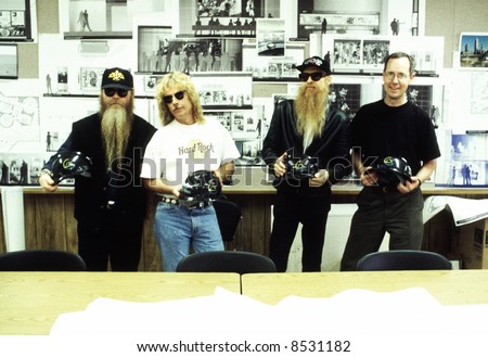 Musicians Billy Gibbons, Dust Hill, Frank Beard of ZZ Top, and Curator James Henke tour the site of The Rock and Roll Hall of Fame and Museum during its construction in 1994.