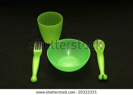 A set of green plastic tableware for kids