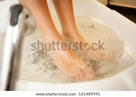 Feet inside water during spa treatment