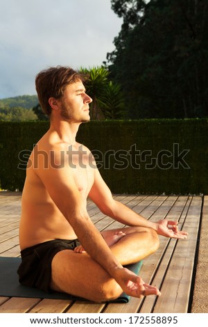 Man doing yoga outside.