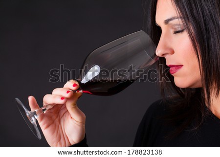 Woman smelling a wine, during wine marriage process.