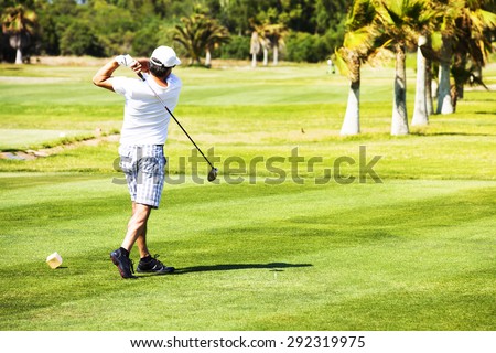 Golf player hit from the tee start at a golf course.