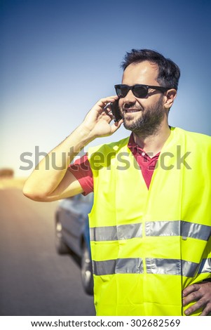 Man calling to insurance company after a car breakdown.