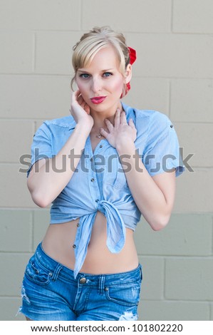 Blue eyed blonde in a check shirt and denim shorts