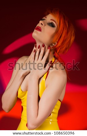 Beautiful pale redhead dressed in yellow latex