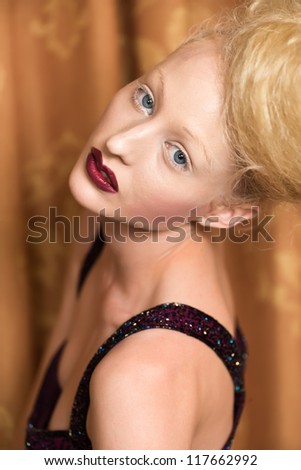 Slender pale blonde in a purple gown