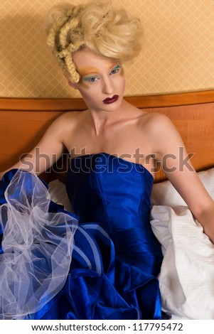 Slender pale blonde in a blue gown