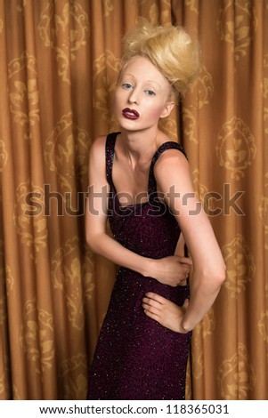 Slender pale blonde in a purple gown