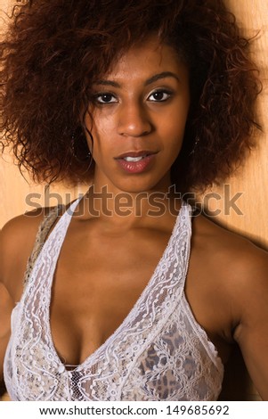 Pretty petite black woman in a white lace blouse