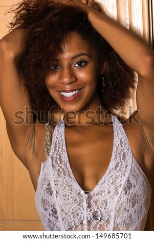 Pretty petite black woman in a white lace blouse