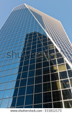 An office tower reflecting another office tower
