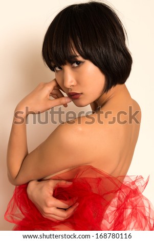Beautiful young Japanese woman wrapped in red tulle