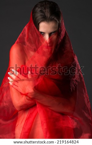 Beautiful slender Ukrainian woman wrapped in red tulle