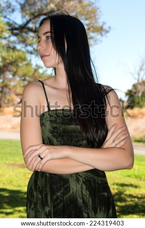 Pretty young brunette in a green tie dye dress