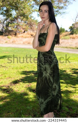 Pretty young brunette in a green tie dye dress