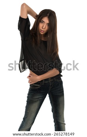 Beautiful petite Eurasian woman in a black blouse and jeans