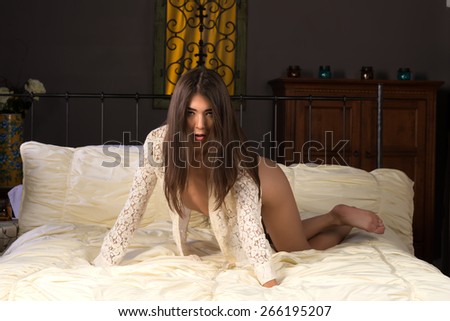 Beautiful petite Eurasian woman in a lace blouse