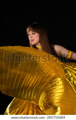 Tall slim brunette in a yellow belly dance costume