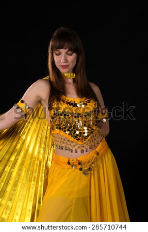 Tall slim brunette in a yellow belly dance costume