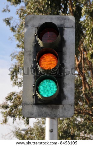 Traffic light on pole: green and yellow