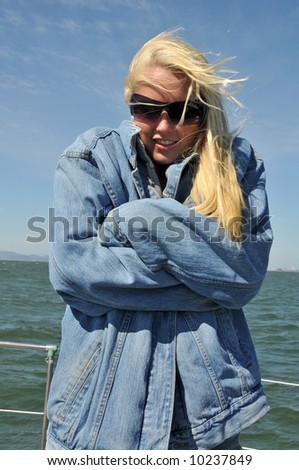 Beautiful blonde bundled up against the cold of a boat ride in San Francisco Bay