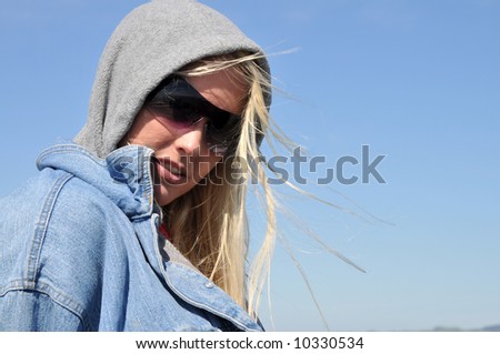 Pretty blonde in hooded sweatshirt and denim jacket
