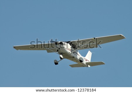 Small plane coming in for a landing against a clear sky