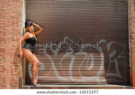 Beautiful blonde in black lingerie in front of a loading dock door