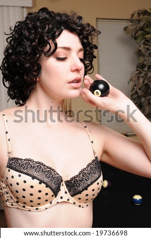 stock photo Brunette in lingerie fondling an eight ball