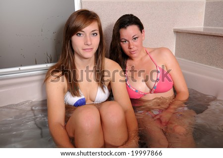 stock photo Two pretty teens in a jacuzzi