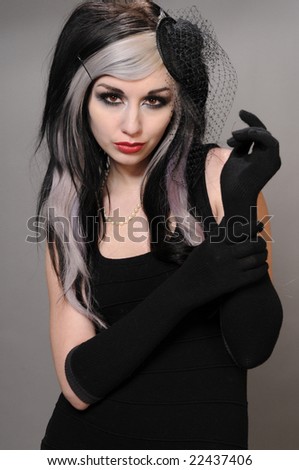 Pretty girl with goth hair in a vintage black dress