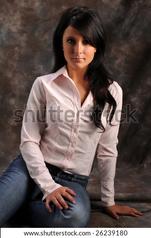 Pretty young brunette in a pink shirt and blue jeans