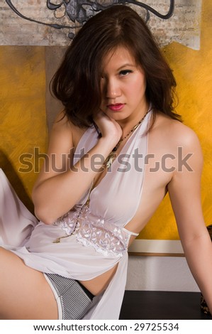 Pretty young Asian woman in a white nightgown