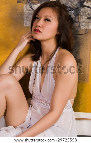 Pretty young Asian woman in a white nightgown