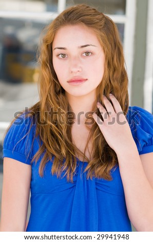 Pretty teenage girl in a blue blouse