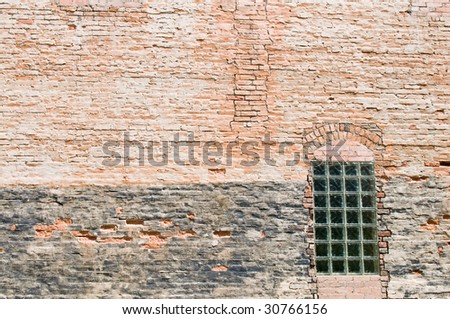 An old brick wall with small glass paned window, Ouray, Colorado
