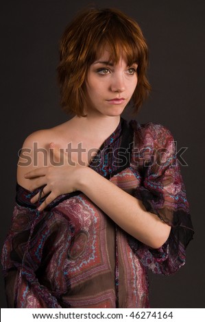 Pretty young brunette in a sheer print blouse