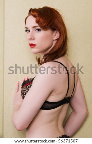 Pretty young redhead dressed in leopard print lingerie