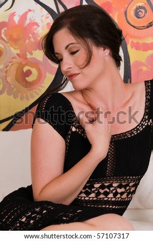 Beautiful brunette in a revealing black knit dress