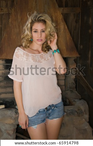 Pretty young blonde in a cream colored blouse