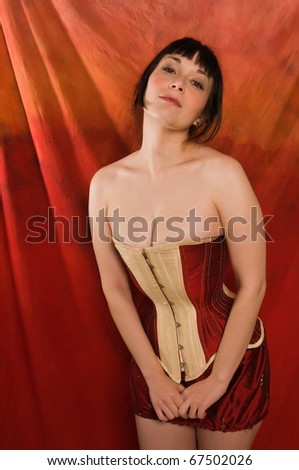 Pretty brunette dressed in a red corset