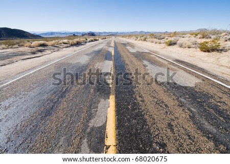 Muddy road through a winter desert scene, Mojave National Preserve, California