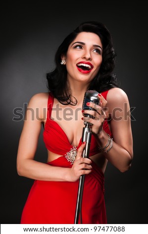 stock photo brunette chanteuse in a vintage red dress 97477088