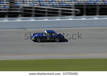 Blue Porsche 911 racing at Daytona International Speedway - Rennsport Reunion III