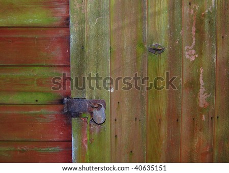 An old shed door with a padlock