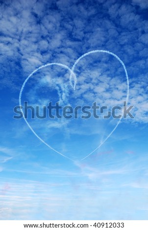 Heart shape skywritten against a blue summer sky by Red Arrows display team