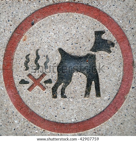 No dog fouling sign, set in a stone paving slab.